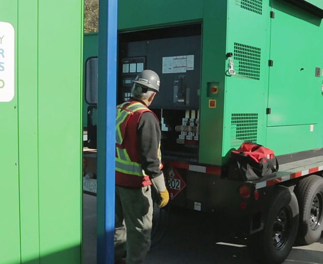 Construction Worker Turning on Temporary Power Supply